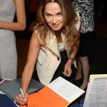 Author Angella Nazarian signs a book at Women's Forum for the Economy & Society New York Cocktail at French Institute Alliance Francaise on September 17, 2015 in New York City.  (Photo by Andrew Toth/Getty Images for Assouline)
